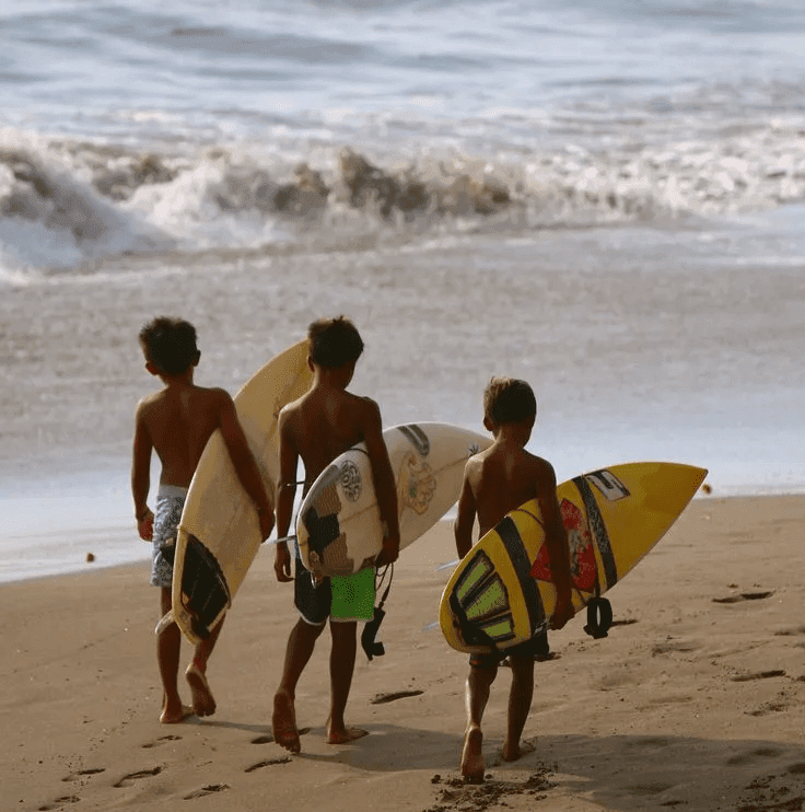 Kids with surfboards on the beach
