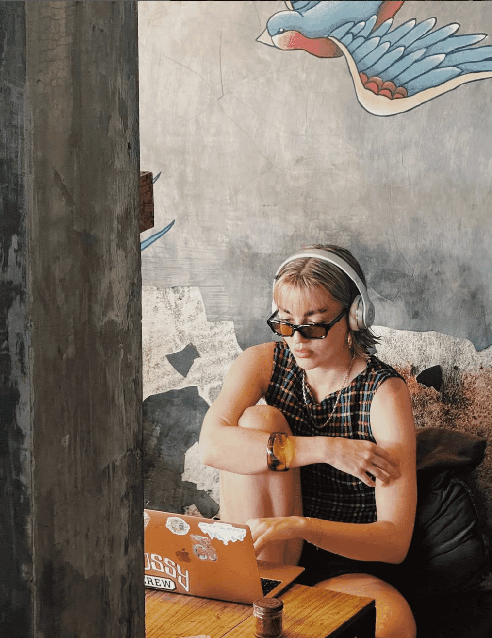 girl on her computer in a minimal brut cafe