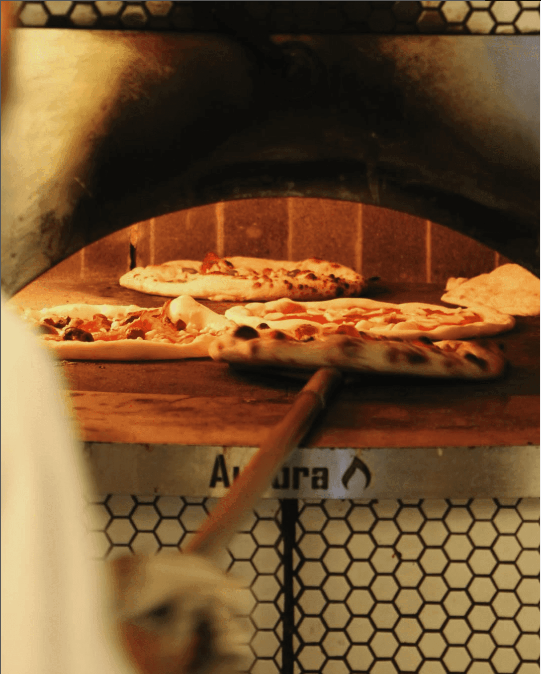 pizzas baking in the oven in an italian restaurant